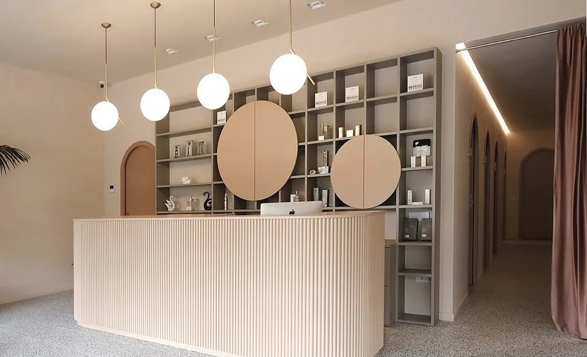 La reception di Clinic Beauty a Sassuolo, con il banco e le lampade a sfera